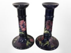 A pair of William John Moorcroft candlesticks, height 20.