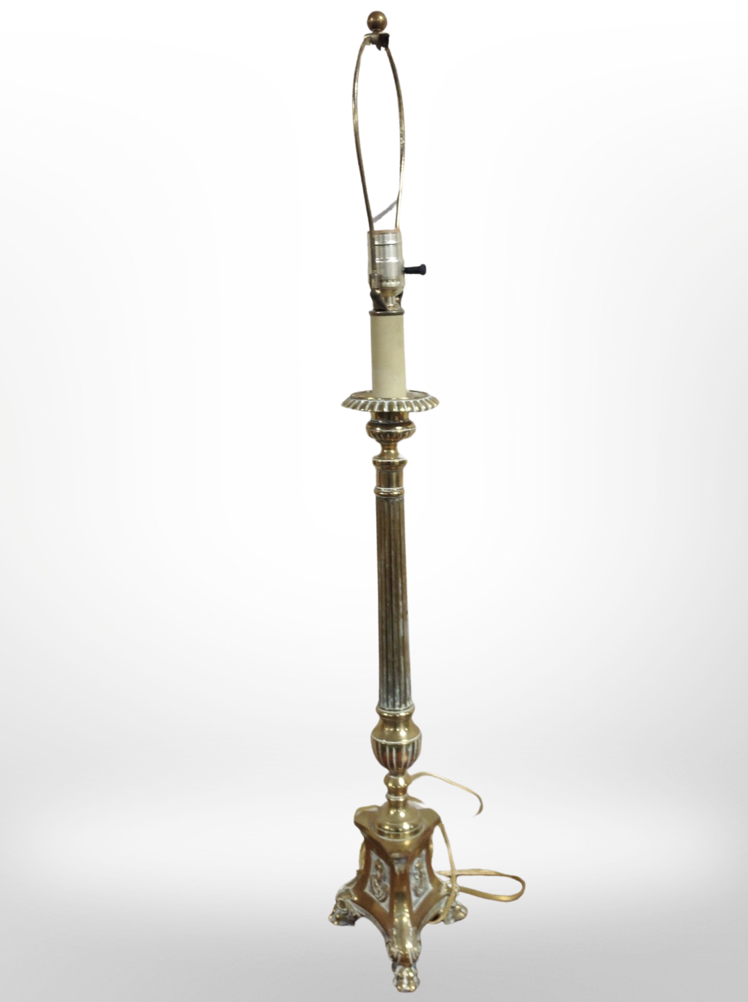 A brass table lamp on lion paw feet, height 89cm (continental plug).