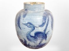 A 20th-century blue-glazed earthenware vase decorated with herons, height 30cm.