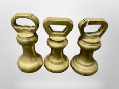 Three large brass bell weights
