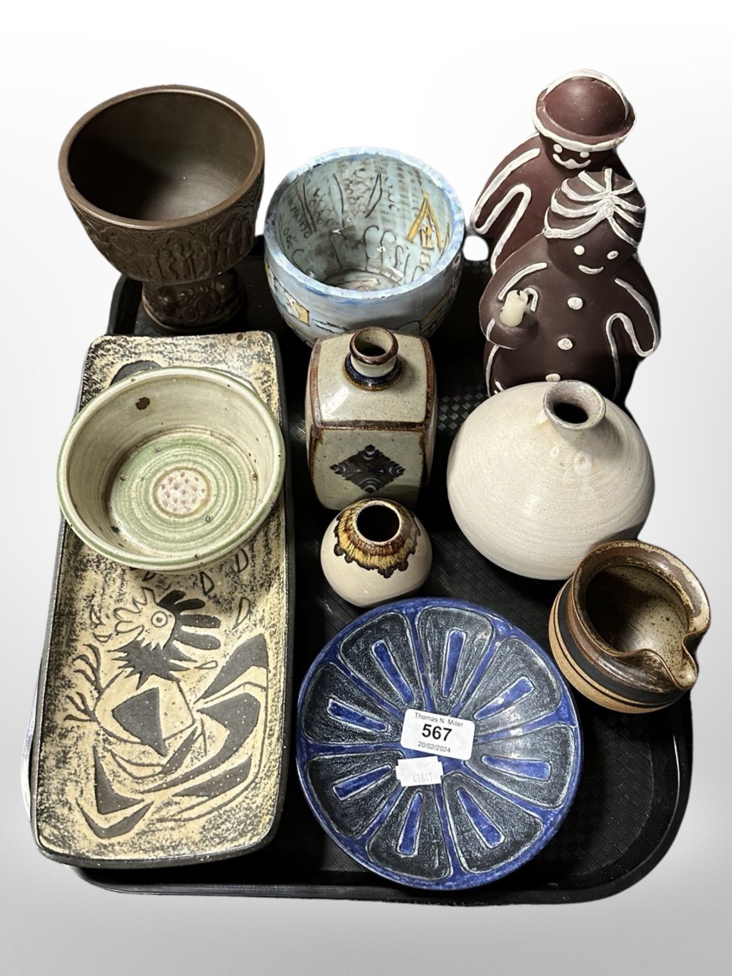 A group of 20th-century Danish studio pottery including shallow bowls, gingerbread figures, vases.