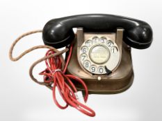 A vintage copper and Bakelite telephone.