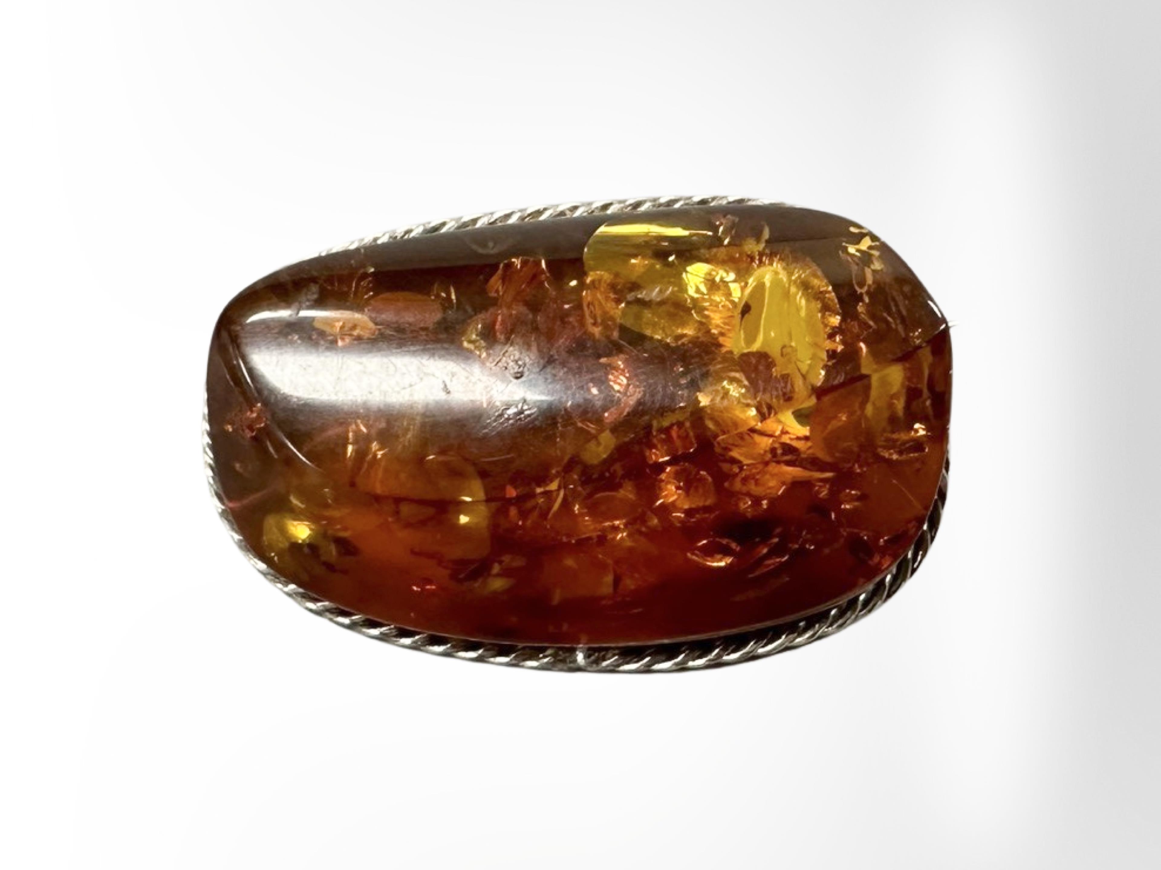 A Baltic amber and white metal brooch, 21.9g, length 52 mm.
