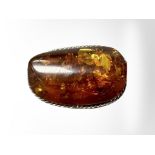 A Baltic amber and white metal brooch, 21.9g, length 52 mm.