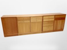 A contemporary Danish four-part low sideboard fitted cupboards and drawers,