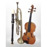 A box of musical instruments including violin, trumpet, two recorders.