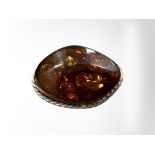 A Baltic amber and white metal brooch, 11.6g, length 46 mm.