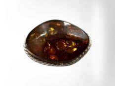 A Baltic amber and white metal brooch, 11.6g, length 46 mm.
