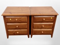 A pair of contemporary pine three-drawer bedside chests, each 55cm x 45cm x 62cm.