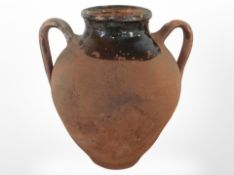 A twin-handled terracotta urn, height 33cm.