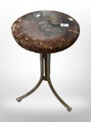 An early 20th-century bar stool on metal support.