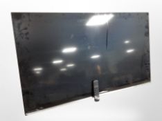 A 54" LCD TV and remote
