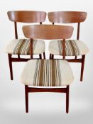 A set of four 20th century teak framed dining chairs in striped upholstery