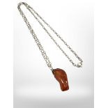 A polished chunk of amber mounted on chain.