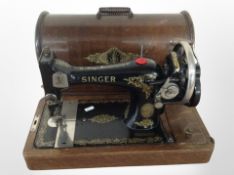 An antique Singer hand sewing machine No. F9737767.