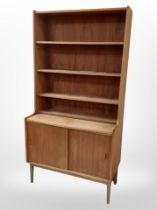 A 1970s Danish teak open bookcase with sliding-door cupboards beneath, 90cm x 44cm x 174cm.