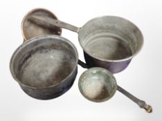 A 19th-century copper cast iron-handled cooking pan, further ladle, a pewter bowl, and a brass bowl.