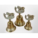Three graduated brass bells, height 12cm.