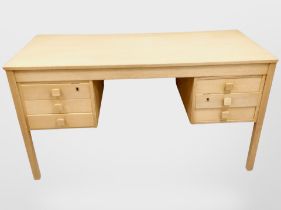 An early 20th-century Danish blonde oak twin-pedestal writing desk fitted six drawers,