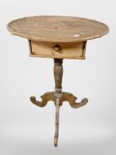 An early 19th-century pine oval tripod occasional table fitted with drawer, 54cm x 37cm x 75cm.