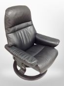 A Norwegian stressless black leather swivel armchair.