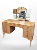 A Vesper furniture beech mirror-back dressing table fitted seven drawers, 122cm x 51cm x 130cm,