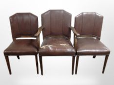 A set of five early 20th-century oak-framed brown leather dining chairs comprising of one carver