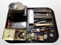 A group of antique cut-throat razors, AA badge, medals, crucifix, cigarette case,