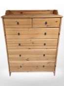 A contemporary pine effect six-drawer chest, 95cm x 50cm x 123cm.