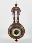 A carved beech barometer, height 43cm.