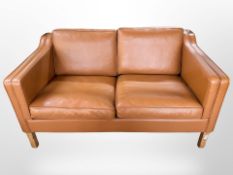 A late 20th-century Danish tan leather two-seater settee, 145cm x 83cm x 80cm.