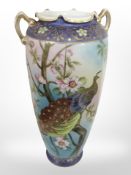 A 20th-century Japanese export twin-hand porcelain vase depicting a peacock, height 37cm.
