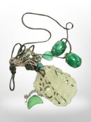 A large carved Chinese jade pendant, a carved crescent jade on silver chain,