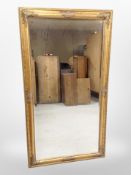 A period-style gilt overmantle mirror, 133cm x 72cm.