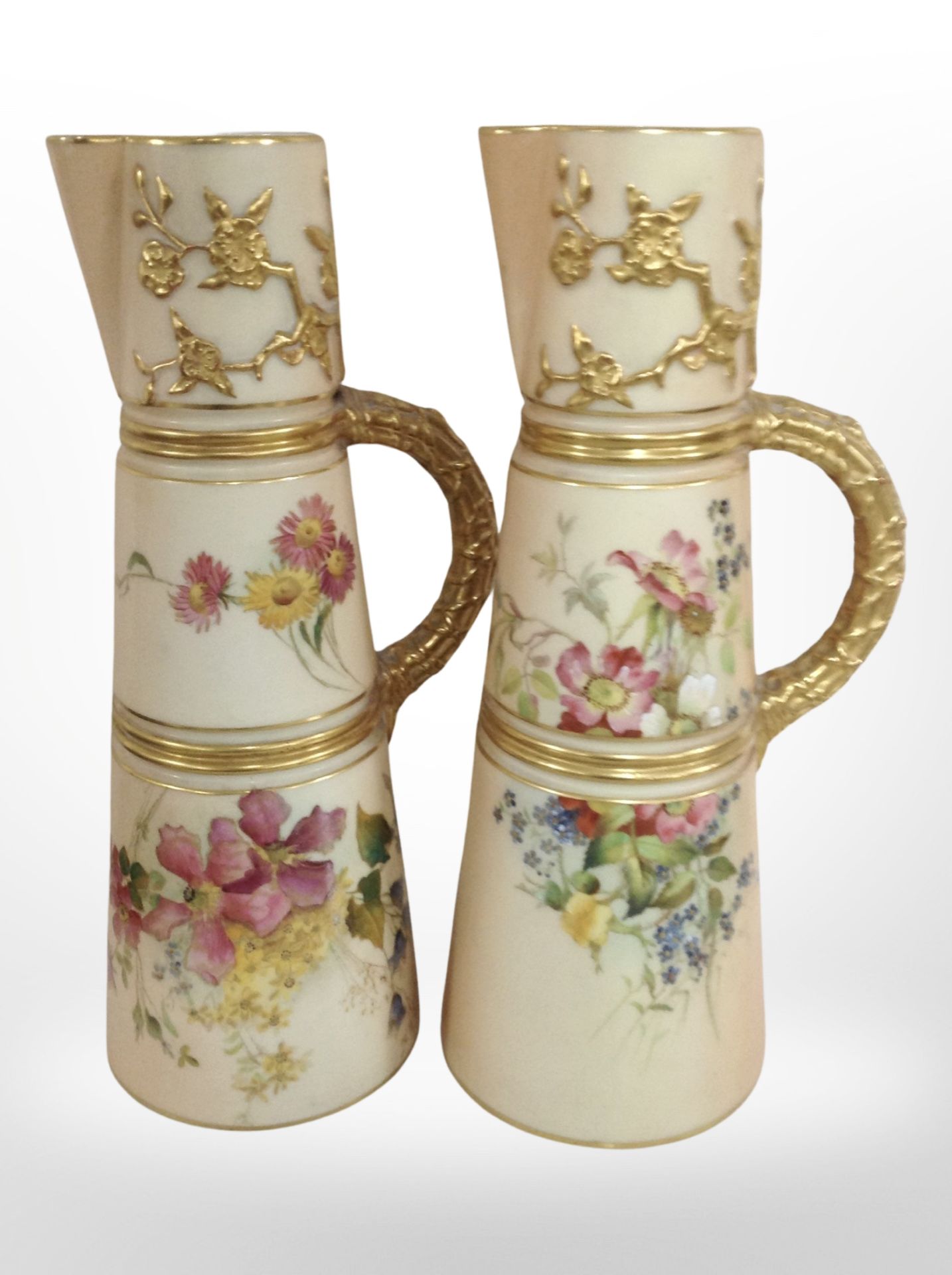 Two very similar Royal Worcester blush ivory porcelain tapered jugs, shape number 1047,