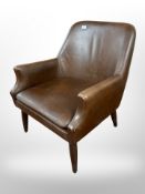 A 20th-century Danish brown leather armchair on tapered legs.