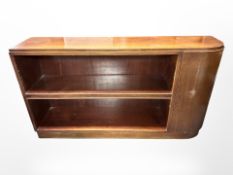An early 20th-century Danish mahogany open low bookcase with curved cupboard door,