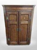 An early 19th-century oak and satinwood-inlaid hanging corner cabinet, height 116cm.