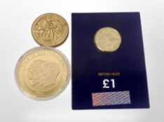 A gold-plated commemorative coin, 'The Year of the Three Kings, 1936', and two other coins.