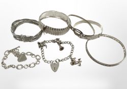 Seven silver charm and other bracelets, bangles etc CONDITION REPORT: 128.