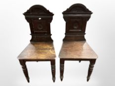 A pair of 19th century carved oak hall chairs,