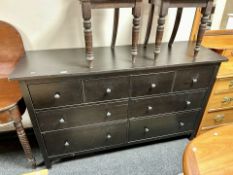 A contemporary stained pine chest of eight drawers,