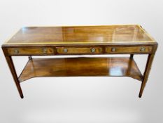 A reproduction mahogany and burr walnut side table fitted with three drawers,