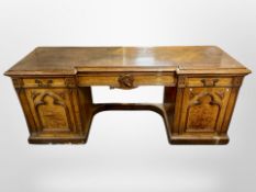 A Victorian Gothic style carved oak inverted breakfront sideboard,