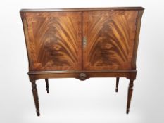 A reproduction double door cabinet with plate glass top,