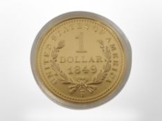 A USA $1 gold-plated coin, 1849.
