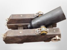 A reproduction model of a mid 19th century mortar on stained pine carriage,