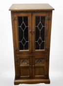 A reproduction oak entertainment cabinet,