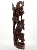 A South East Asian carving depicting mythical beasts fighting,