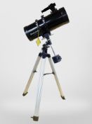 A Celestron Power Seeker 127EQ telescope on tripod, and box containing further accessories,